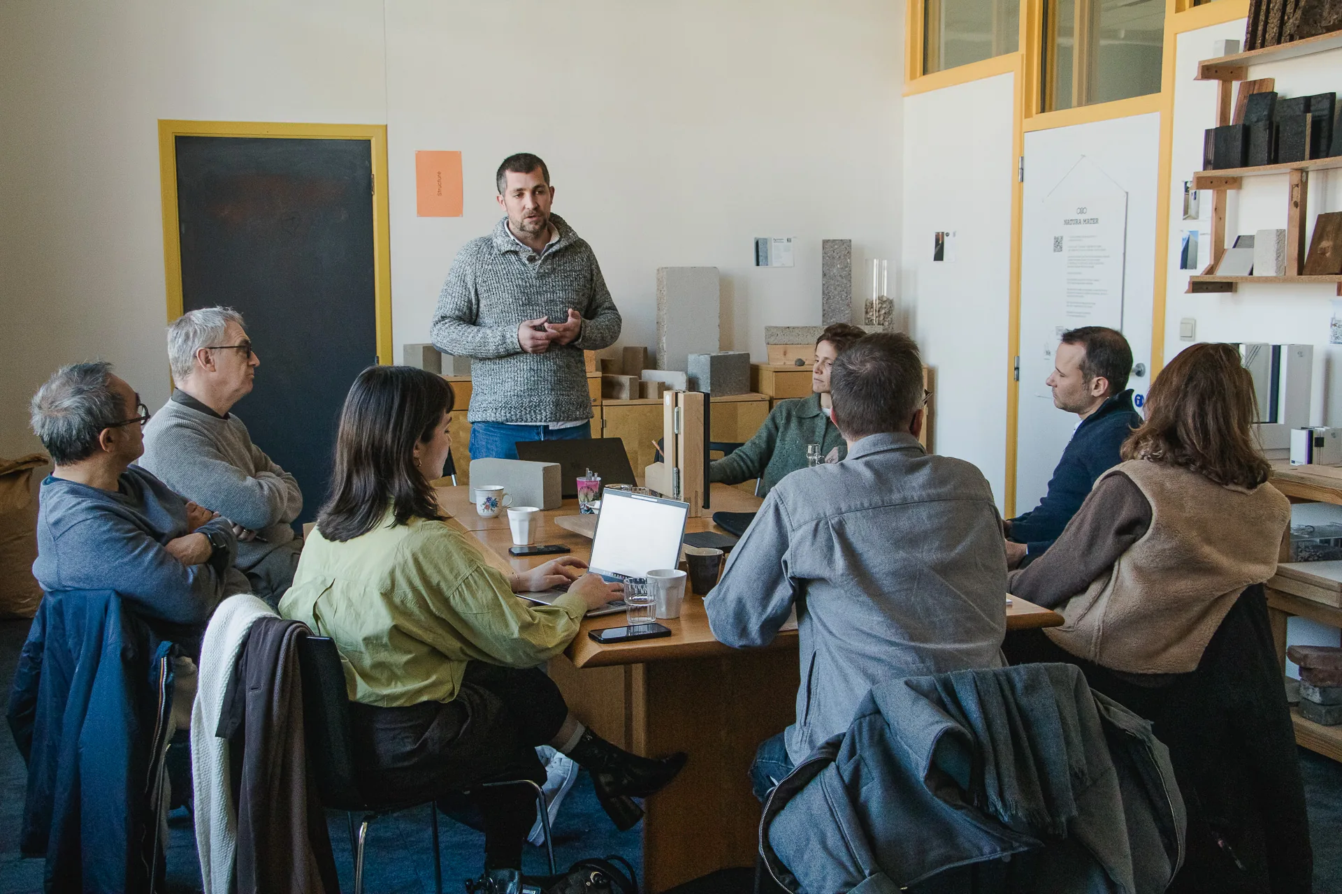 Project workshop around the table at the Materatek, samples within reach